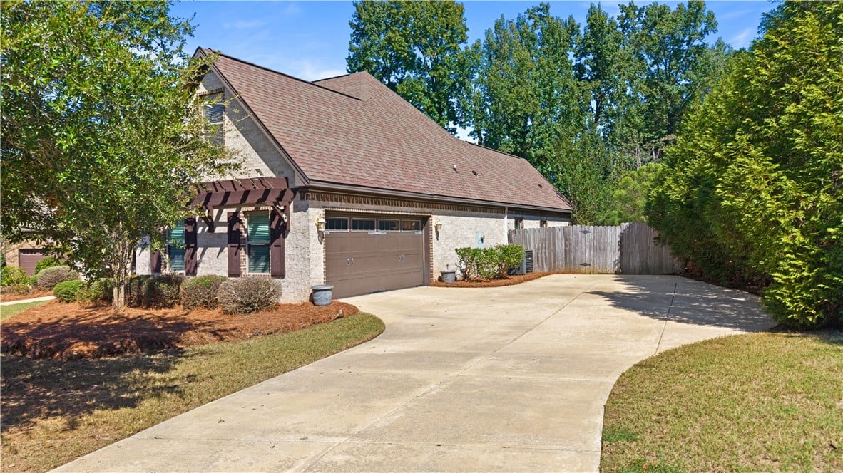2306 Morgan Dr, Auburn, AL 36830, An expansive concrete driveway leads to the side-e