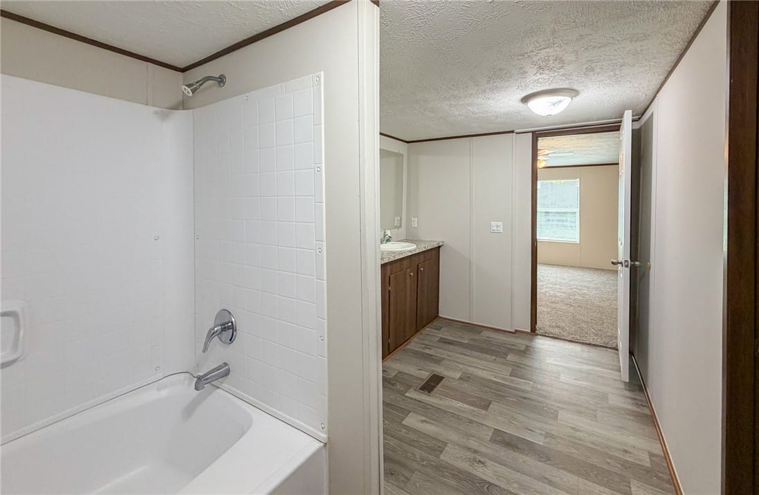 751 Ellis Rd, Shorter, AL 36075, This bathroom features a bathtub and a vanity, wit