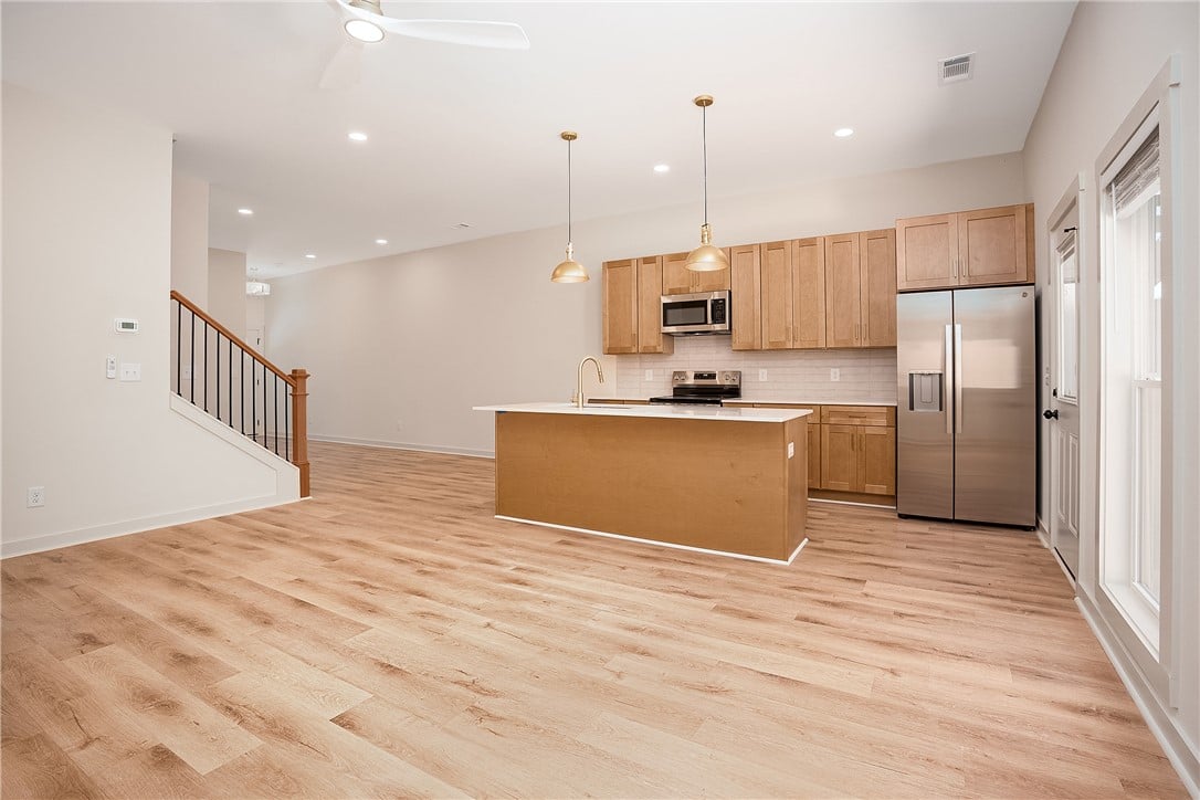 1427 Ashford Court, Auburn, AL 36830, Warm wood floors flow through a contemporary open-