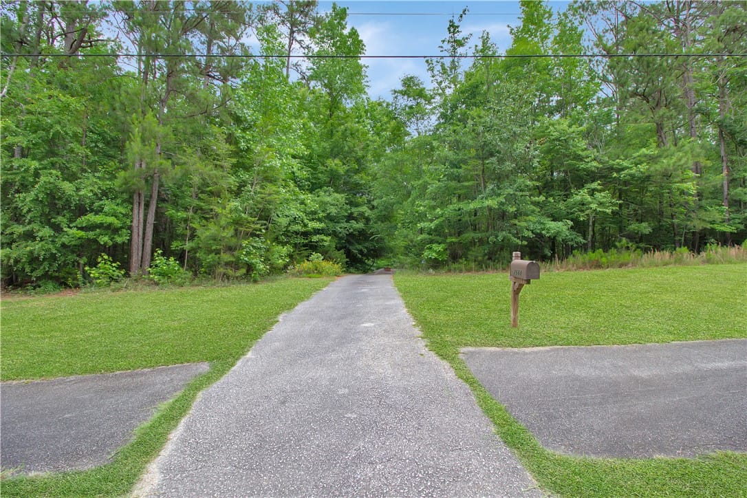 2668 Wire Rd, Auburn, AL 36832, A long, private driveway guides you through a sere