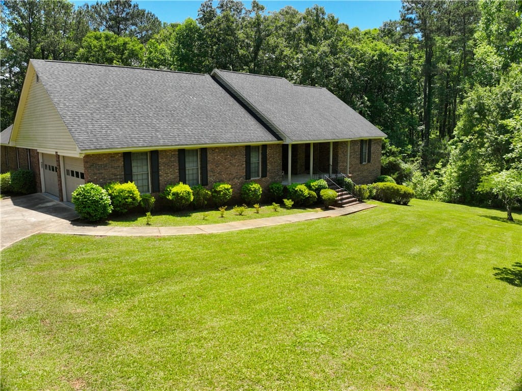 1016 Co Rd 515, Lanett, AL 36863, A classic brick exterior, lush green lawn, and int