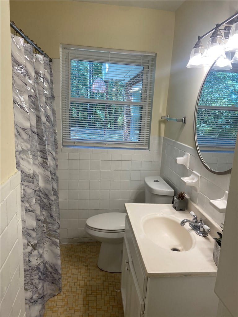 1103 Bibb St, Tuskegee, AL 36088, A window-filled bathroom with tiled walls and patt