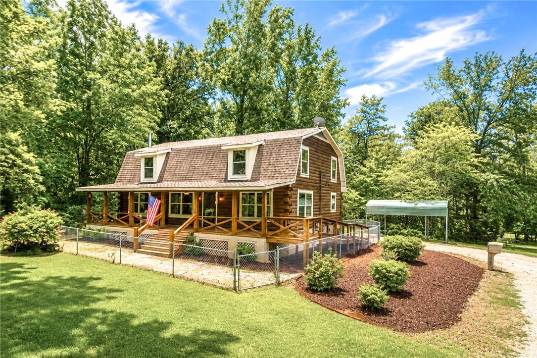 1504 Grand National Pkwy, Opelika, AL 36801, A charming log home with a welcoming covered porch